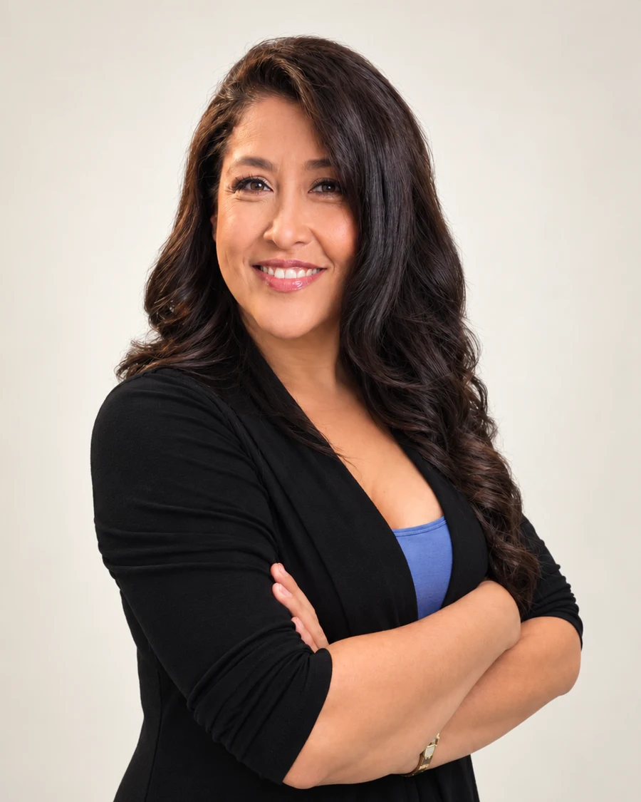 Lucia Diaz-Gajadhar smiling with arms crossed, wearing a black cardigan